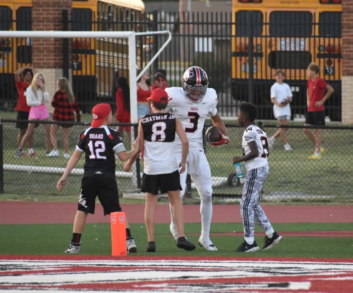 Jacobe Johnson (3) celebrates with some fans after scoring a touchdown during Mustang's win at Yukon in the 2022 season.